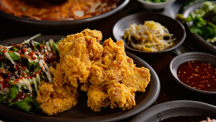 Korean Grilled BBQ combo sets with fried chicken on the traditional grill table, and pickle dishes