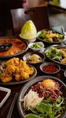 Korean Grilled BBQ combo sets with fried chicken, beef tartare on the traditional grill table, and...