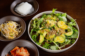 Korean Grilled BBQ combo sets with cucumber salad on the traditional grill table
