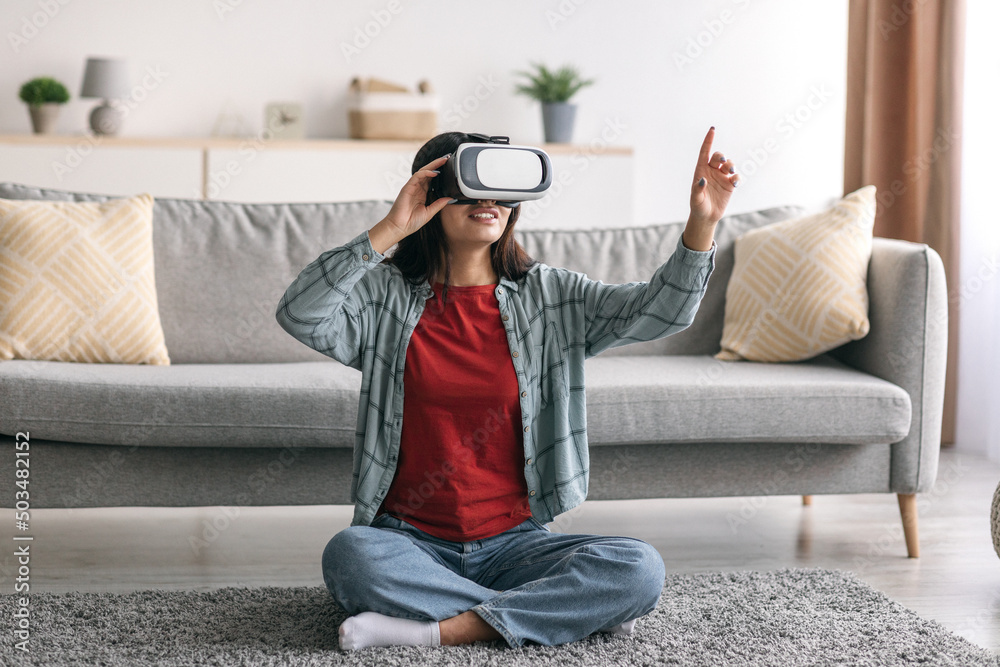 Wall mural happy millennial arab woman in virtual reality glasses exploring cyberspace, playing interactive vid