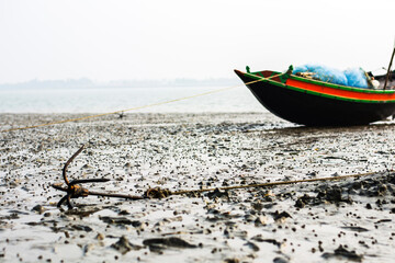 Close-up native wooden fishing boat has been anchored on water age of sea