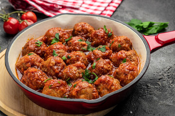 Traditional spicy meatballs in sweet and sour tomato sauce. Restaurant menu, dieting, cookbook recipe top view