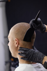 applying cream or ointment or paint or medicine on the head to the hair. head hair treatment, hair...