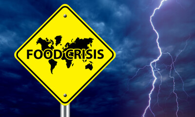 Problem hunger. Food crisis logo in front of world map. Yellow road sign on background thunderstorms. Concept solving problem of hunger at international level. Food crisis on different continents