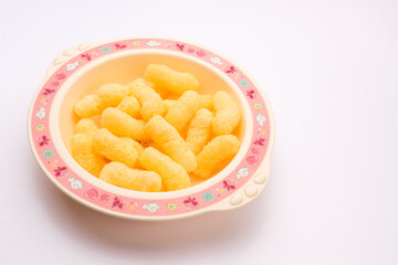 sweet corn sticks in a plate on a white background