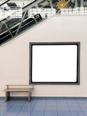 Blank billboard mock up on the wall beside the escalator at shopping mall. Advertising concept - stock photo