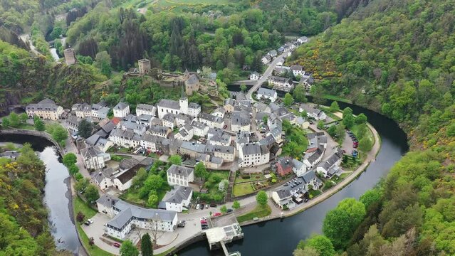 Aerial view of Esch-sur-Sure, medieval town in Luxembourg, dominated by castle, canton Wiltz in Diekirch. Forests of Upper-Sure Nature Park, meander of winding river Sauer, near Upper Sauer Lake.