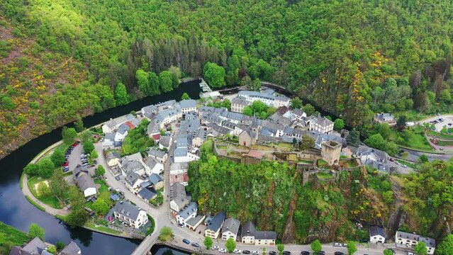 Aerial view of Esch-sur-Sure, medieval town in Luxembourg, dominated by castle, canton Wiltz in Diekirch. Forests of Upper-Sure Nature Park, meander of winding river Sauer, near Upper Sauer Lake.