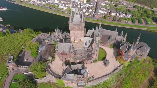Cochem, Germany: Aerial view of Cochem Imperial Castle (Reichsburg Cochem), medieval hill-top castle with quadrangular tower, lush valley of river Moselle - landscape panorama of Europe from above