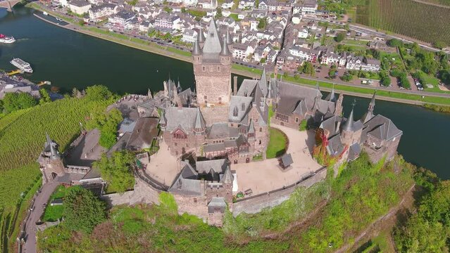 Cochem, Germany: Aerial view of Cochem Imperial Castle (Reichsburg Cochem), medieval hill-top castle with quadrangular tower, lush valley of river Moselle - landscape panorama of Europe from above
