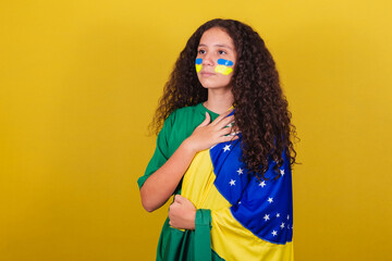 Brazilian, Caucasian girl, soccer fan, Singing national anthem. Nationalism. - obrazy, fototapety, plakaty