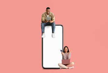 Couple sitting on white empty smartphone screen and using devices