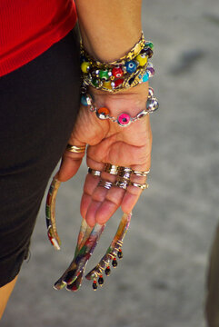 Vertical Shot Of A Woman Showing Off Her Very Long Fingernails