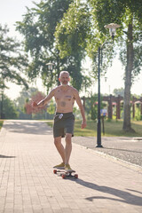 A male skateboarder enjoying a ride in a park