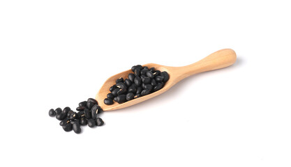 Black beans in wooden scoop isolated on white background