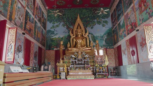 Peaceful Buddha statue and decoration inside of Plai Laem temple in Koh Samui