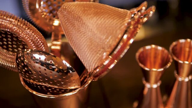 bartender's tool for making cocktails. jigger, shaker, strainer, bar spoon and more. beautiful tool for the job. close-up