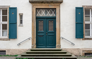 Vintage old doors and windows on the facade of the house.