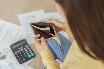 Top view owe asian woman, female sitting on floor stressed and confused by calculate expense from...