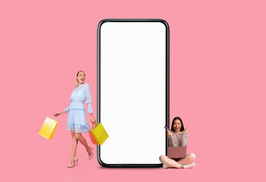 Women posing with white empty smartphone screen and shopper bags