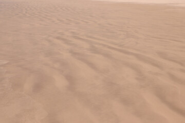Fototapeta na wymiar Wet sand background. Sand texture