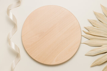 Round wooden desk or stand with palm leaf top view, podium for organic product and food presentation