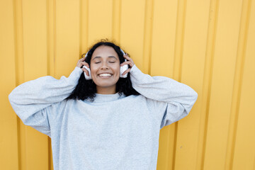 smiling woman with headphones outdoor