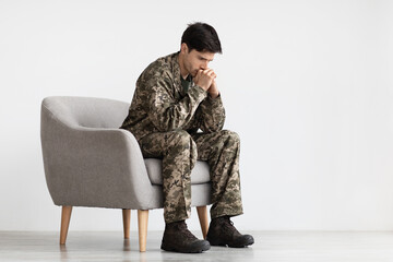 Depressed young military black covering his mouth with palms