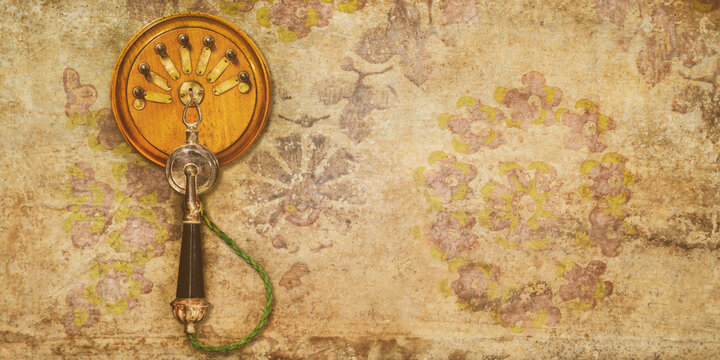 Early twentieth century hanging telephone on a wall with weathered retro flower wallpaper