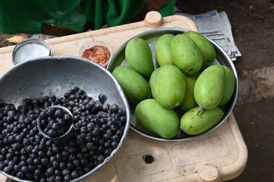 close up of Karanda on pot
Display of cut fruits like  raw mango, berries, pineapple served in bowls