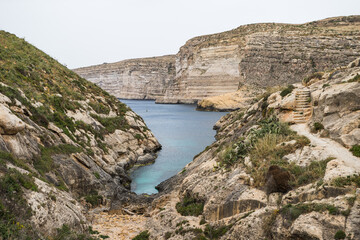 Xlendi Bay surrounded by cliffs