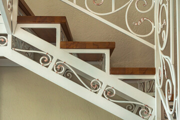 wrought iron white staircase with wooden steps