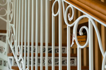 wrought iron white staircase with wooden steps