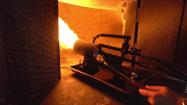 Production oven for making bread. Bakery. Large powerful fire cannon running on waste oil sprays fire throughout furnace and heats it. High fever. Pressure and flames will hit wall. slow motion
