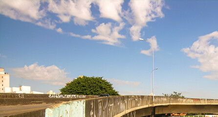 Urban scene on top of bridge with beautiful blue sky and big tree in Belo Horizonte city. Brazil.