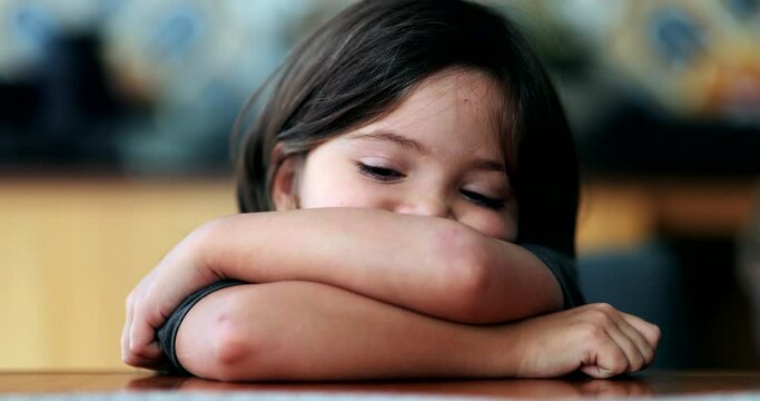Sad little girl depressed child arms crossed