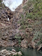 Picture of landscape view of a forest with a lake, hills and trees shot during daytime 