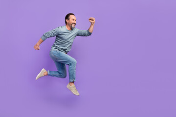 Fototapeta na wymiar Full body profile side photo of mature man run jump hurry speed look empty space isolated over purple color background