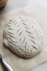 raw dough for baking bread top view. cut out patterns on bread dough. dough in the form of future bread. 