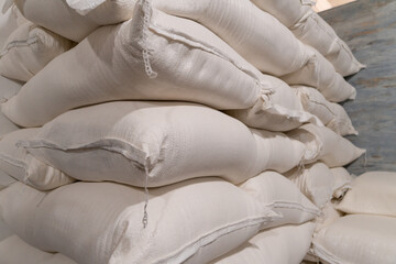 Fototapeta na wymiar Close-up of white flour bags in a warehouse or production