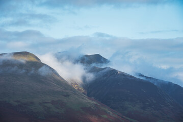 Stunning landscape image of Blencathra covered in low cloud fog and mist viewed from Walla Crag in Lake District