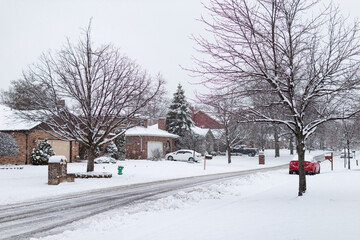 Beautiful Snow Covered Neighborhood Street with Homes during Winter in Suburban Lemont Illinois - obrazy, fototapety, plakaty