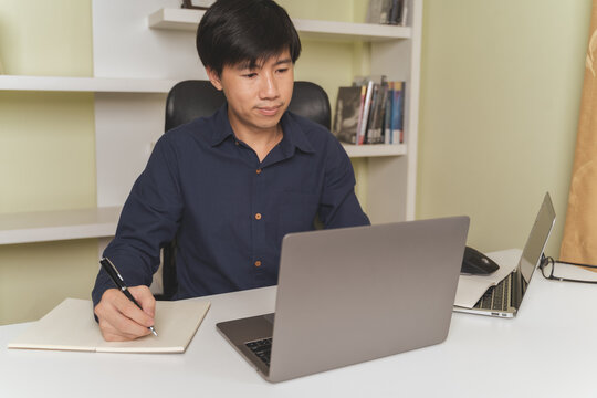 Asian businessman or investor learning trading and investing on laptop for stock and Cryptocurrency trading, investing on online Cryptocurrency and stock platform. Young investor investing concept.