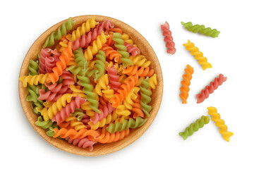 raw Fusilli colored pasta in wooden bowl isolated on white background with clipping path and full depth of field. Top view. Flat lay