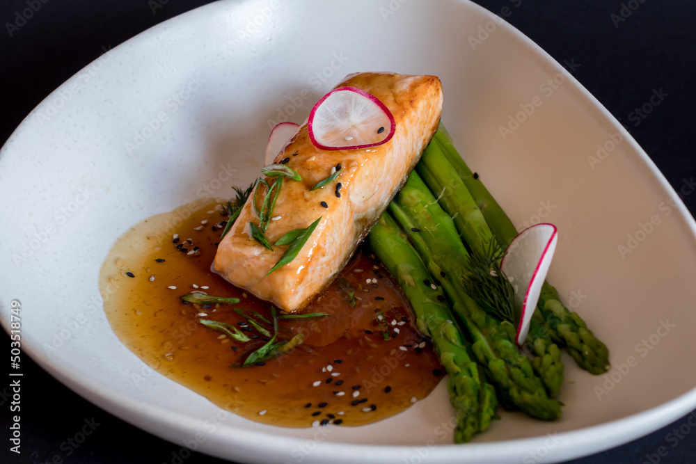 Canvas Prints salmon steak with teriyaki sauce with asparagus on dark table