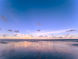 Tropical beach sunset during ebb time. Sea water low tide.