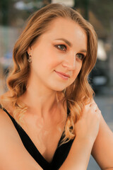 A sweet Caucasian young woman looks at someone, listens carefully, portrait