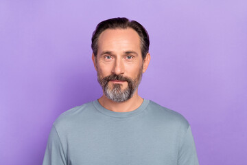 Portrait of good looking positive male in grey color pullover visit barbershop skincare isolated on purple color background