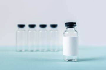 empty medical glass bottles on white and blue background
