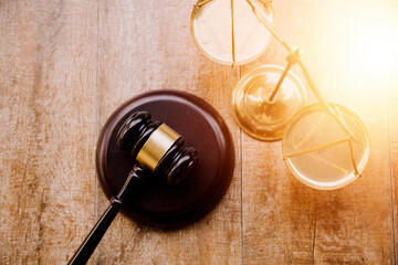 Business and lawyers discussing contract papers with brass scale on desk in office. Law, legal services, advice, justice and law concept picture with film grain effect